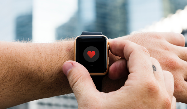 a hand holding a smart watch